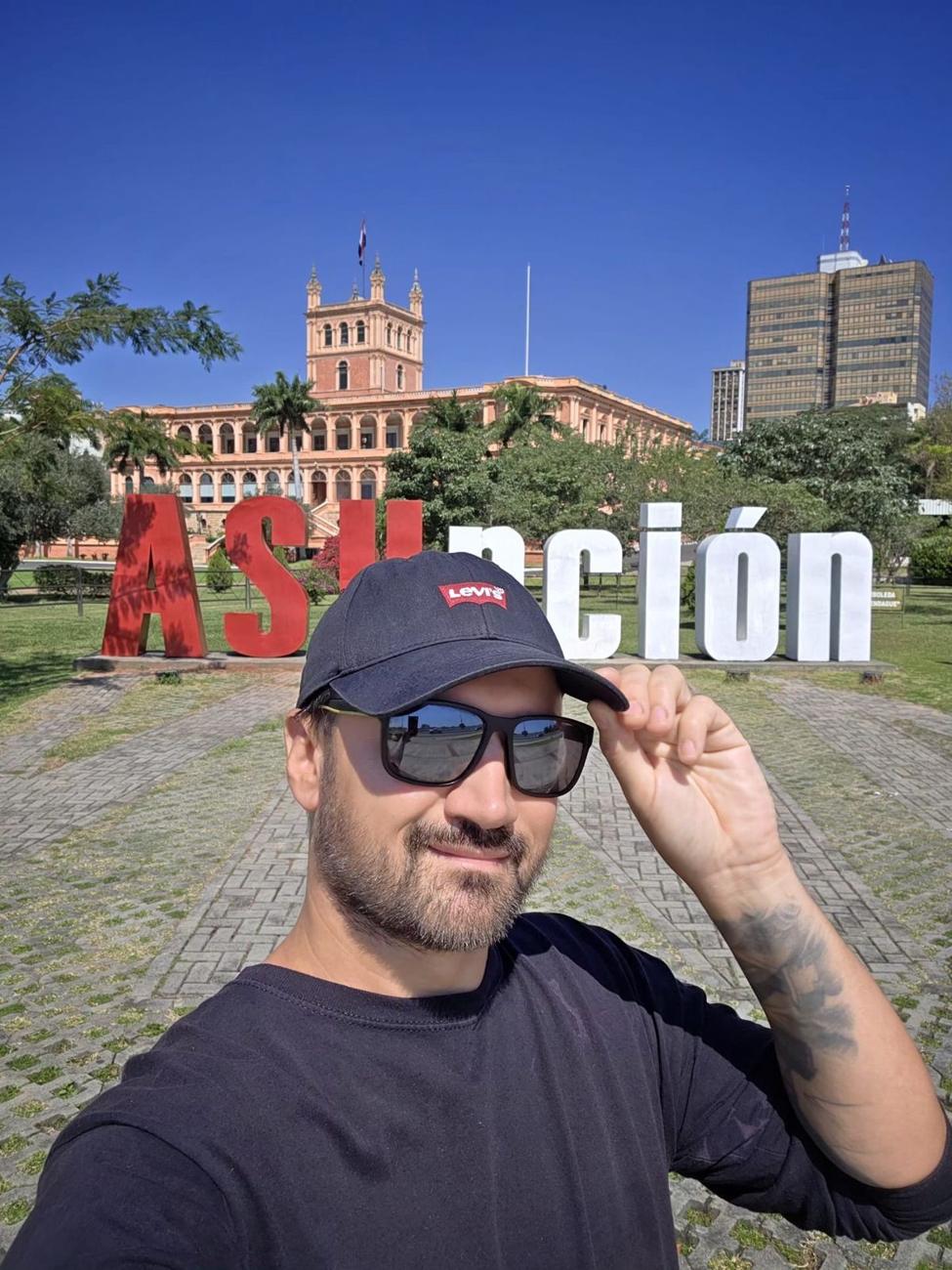 Selfie przed napisem Asunción i Pałacem López